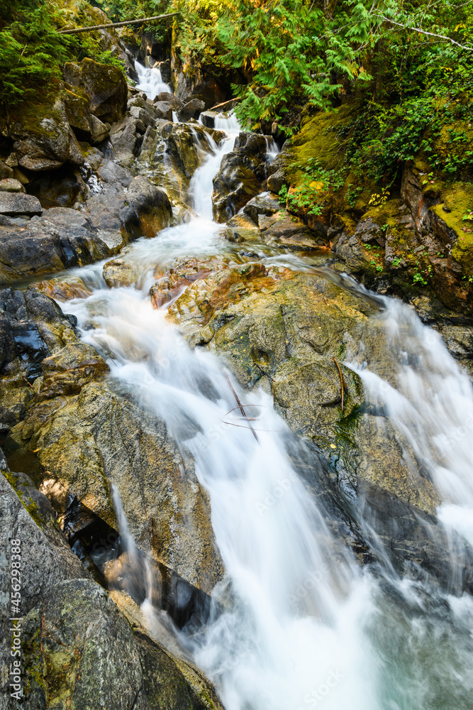 Fototapeta premium Deception Creek cascading across and over rocks at the falls in the Mount Baker Snoqualmie National Forest in Washington State