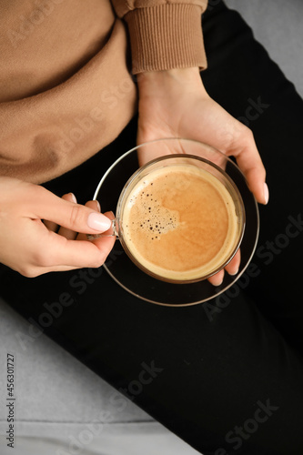 Woman drinking tasty coffee, closeup
