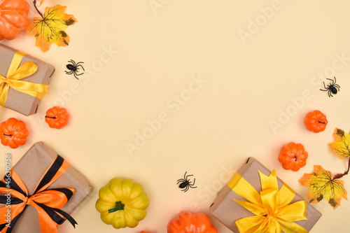 Festive Halloween background with gifts  pumpkins and spiders .