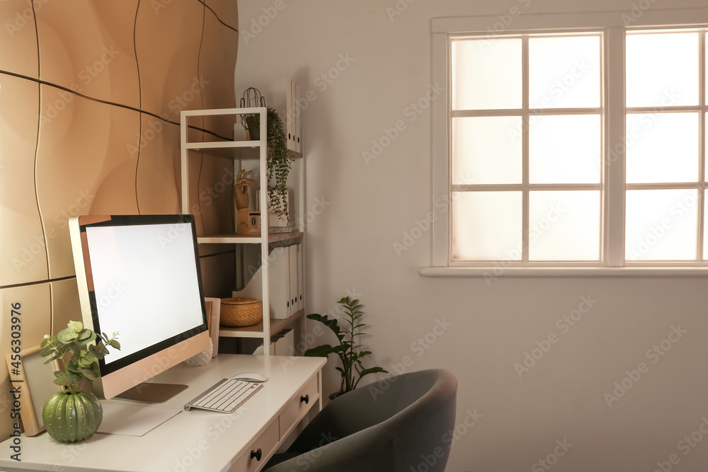 Interior of stylish room with modern workplace