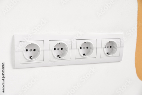 Electric socket with plug on light wall