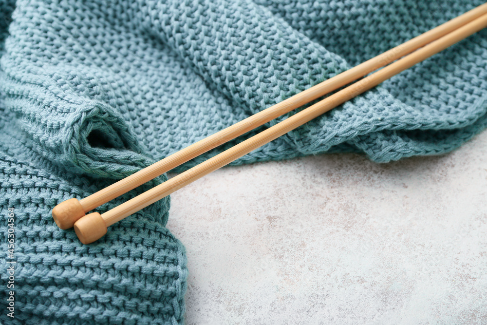 Knitting needles and plaid on light background Knitting needles and plaid on light background