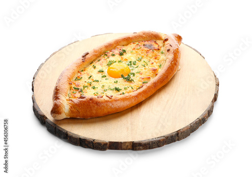 Wooden board with tasty Ajarian khachapuri on white background photo