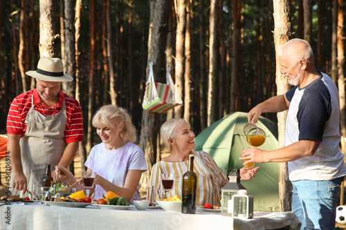 Mature people at barbecue p...