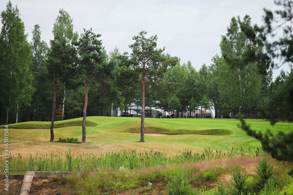 Lake surrounded by greenery on the territory of the golf club. Artificial reservoir. Lake surrounded by greenery on the territory of the golf club. Artificial reservoir.