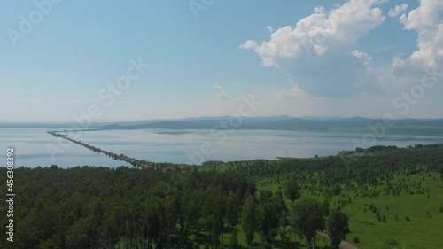 Beryozovskoye reservoir - cooling reservoir of Beryozovskaya GRES. Aerial drone view of lake landscape with road in sunny summer. Berezovskaya GRES is a thermal power plant in the town of Sharypovo photo