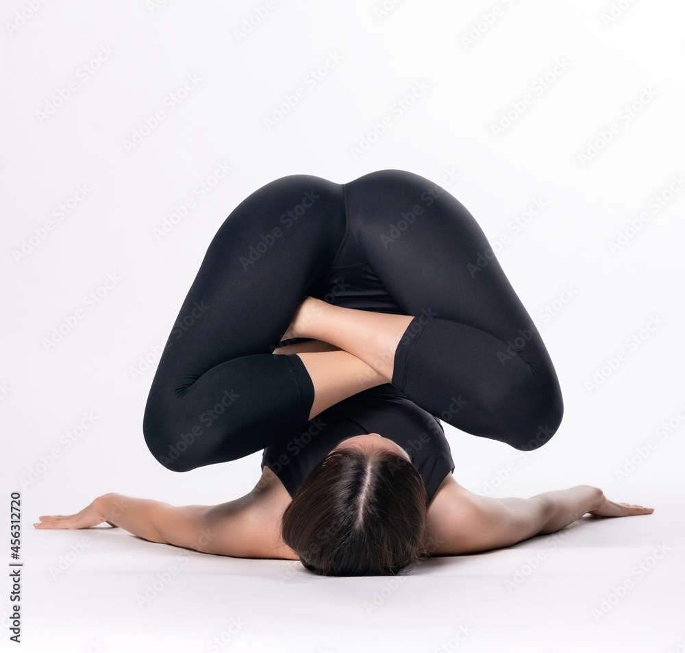 Beautiful sporty woman doing advanced yoga practice on white bac Beautiful sporty woman doing advanced yoga practice on white bac