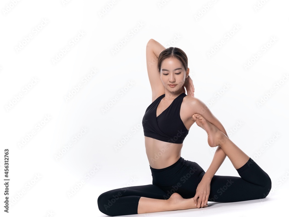 Beautiful sporty woman doing advanced yoga practice on white bac