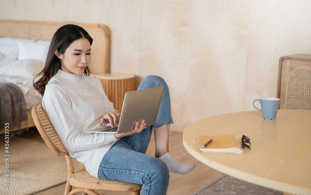 Portrait of sme business asian woman working from home at the computer desktop. Stay home self isolation quarantine in winter. Coronavirus lockdown and flu covid epidemic cosy lifestyle concept Portrait of sme business asian woman working from home at the computer desktop. Stay home self isolation quarantine in winter. Coronavirus lockdown and flu covid epidemic cosy lifestyle concept