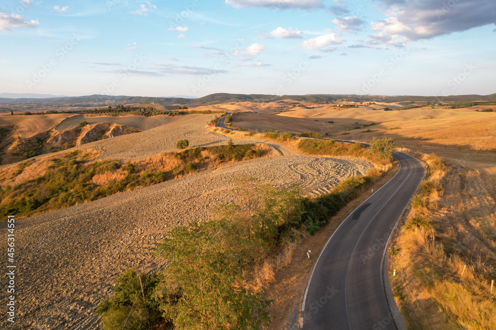 Beautiful idyllic late summer landscape of Toscana with plants, hills, trees and road. Sunny evening or morning in Italy. Vacation, recreation mood. Agricultural fields of Tuscany Beautiful idyllic late summer landscape of Toscana with plants, hills, trees and road. Sunny evening or morning in Italy. Vacation, recreation mood. Agricultural fields of Tuscany