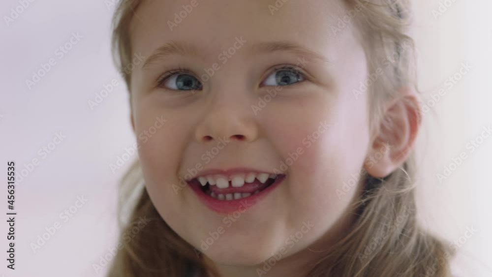 portrait happy little girl smiling with playful expression looking joyful child enjoying childhood 4k footage portrait happy little girl smiling with playful expression looking joyful child enjoying childhood 4k footage