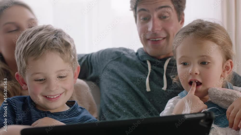 happy family using tablet computer at home mother and father with children watching entertainment playing game on touchscreen device learning having fun together 4k footage happy family using tablet computer at home mother and father with children watching entertainment playing game on touchscreen device learning having fun together 4k footage