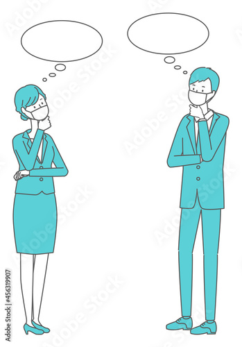 考える　マスクを着けたスーツの男女