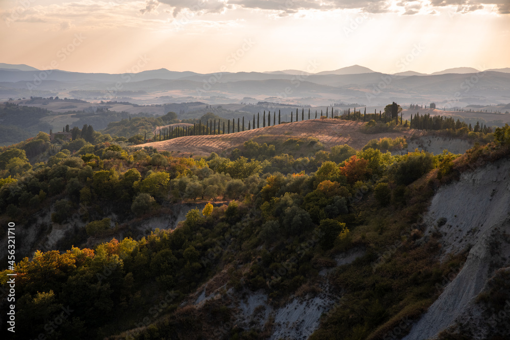 Beautiful idyllic sunny late summer landscape of Toscana with hills, trees, fields and forests. Evening or morning in Italy. Vacation, recreation mood. Agricultural fields of Tuscany 