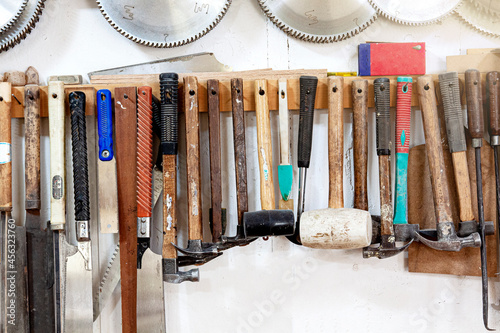 The tools on the wall of the woodworking shop.