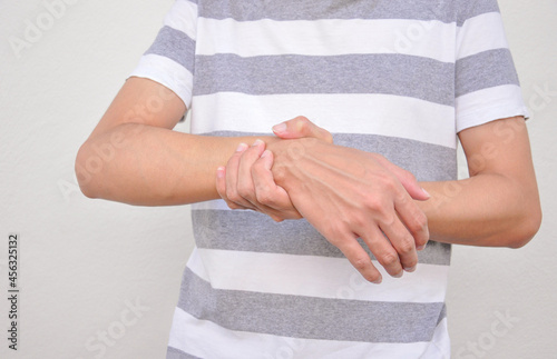 a man support his arms (selective focus) which pain,numbness,weakness,paralysis. concept of Guillain barre syndrome caused by autoimmune disorder photo