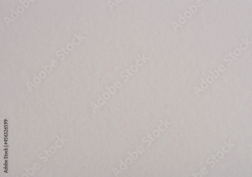 Pale slate colour paper background. Mottled paper texture.