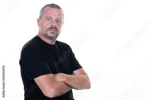handsome serious man dressed in casual black shirt aside copy space isolated on white background