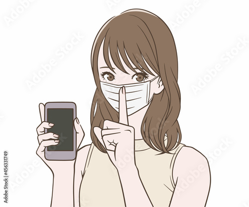 スマートフォンを持ち、人差し指を立てるマスクをつけた女性