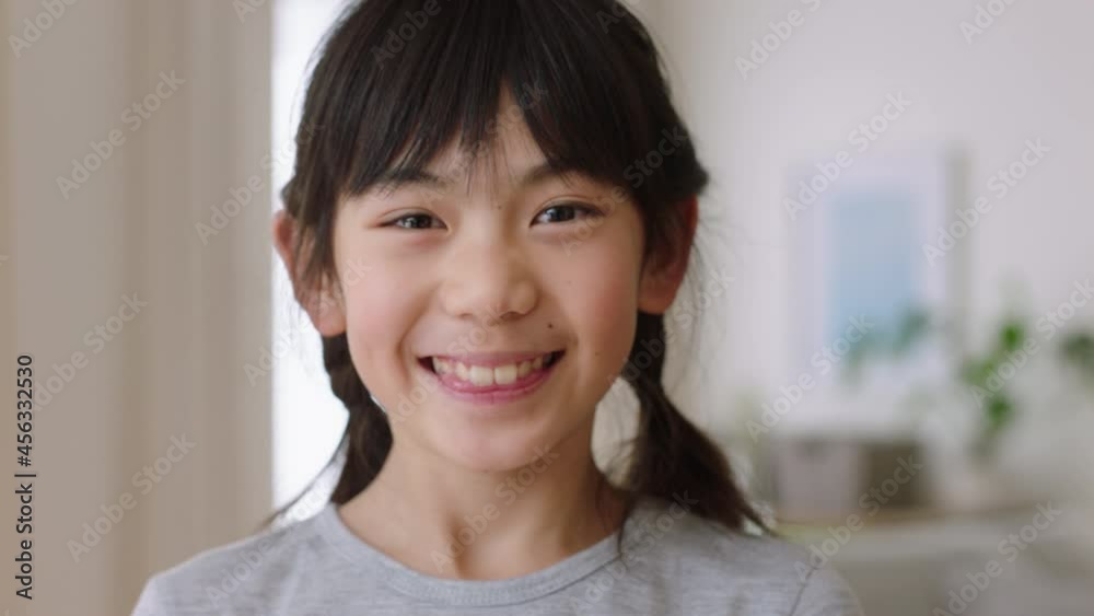 portrait of happy little asian girl smiling playfully having fun positive childhood 4k footage portrait of happy little asian girl smiling playfully having fun positive childhood 4k footage