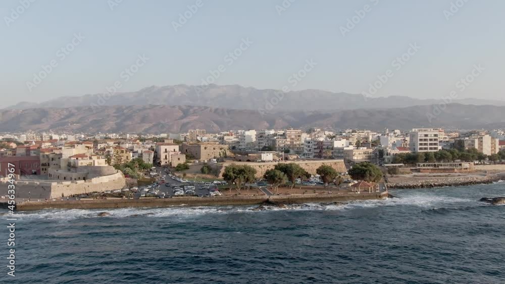 Apartment buildings district on sea coastline in Chania city, Crete, aerial drone view with vertigo effect Apartment buildings district on sea coastline in Chania city, Crete, aerial drone view with vertigo effect
