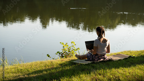 Laptop outdoor business technology. Student girl person work on tablet, computer in summer park. Online woman in nature outside. Happy hipster young distance learning concept.