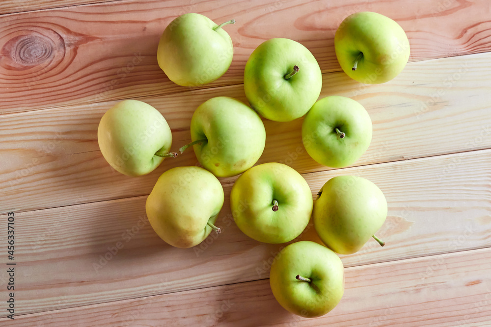 Young organic apples lie on a wooden table Young organic apples lie on a wooden table