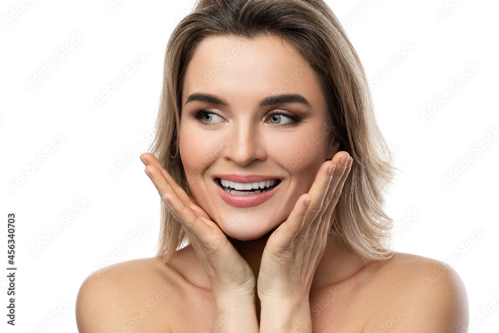 Beautiful blond woman with long wavy hair and smooth skin against white background Beautiful blond woman with long wavy hair and smooth skin against white background