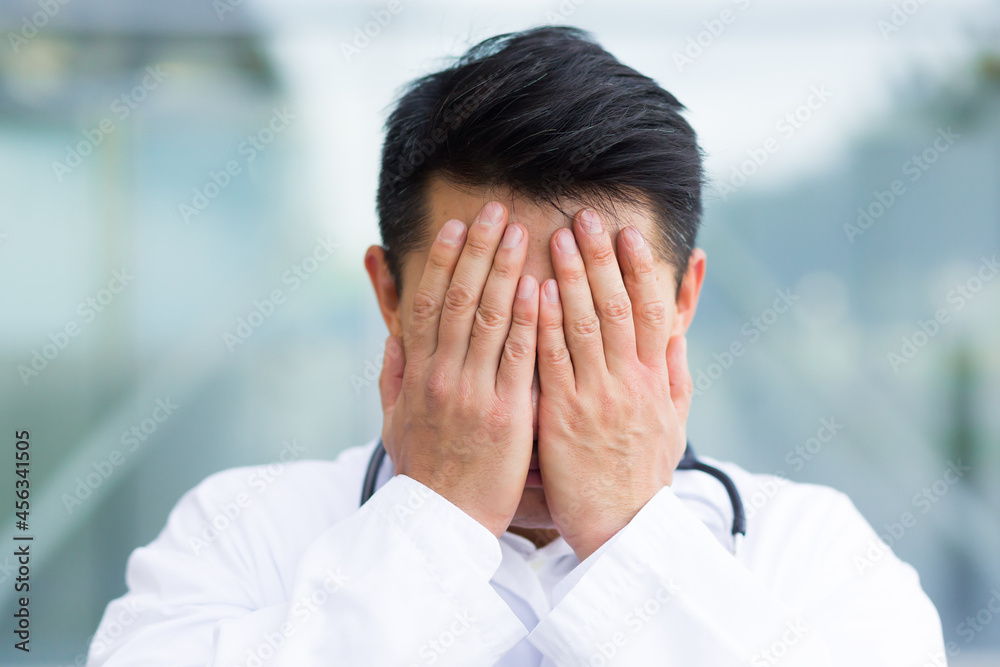 portrait of doctor asian man tired after work close up photo