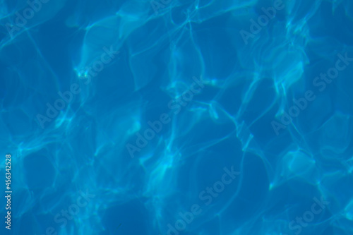 Surface of water. Abstract background of t texture of water surface with refraction of sunlight and reflections on water surface. 