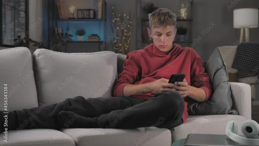 digital addiction dependence concept,teenager boy sits on sofa using smart phone mobile online,timelaspe day to night,time lapse of adolescent guy holding smartphone spending all day browsing internet digital addiction dependence concept,teenager boy sits on sofa using smart phone mobile online,timelaspe day to night,time lapse of adolescent guy holding smartphone spending all day browsing internet