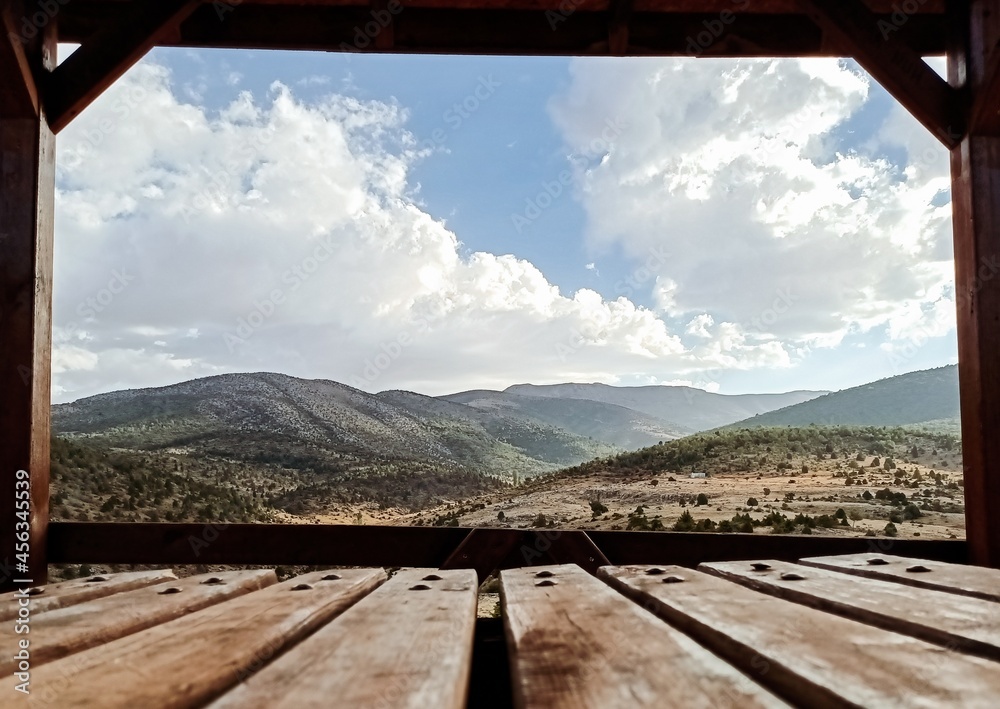 Looking at the mountains from a wooden house