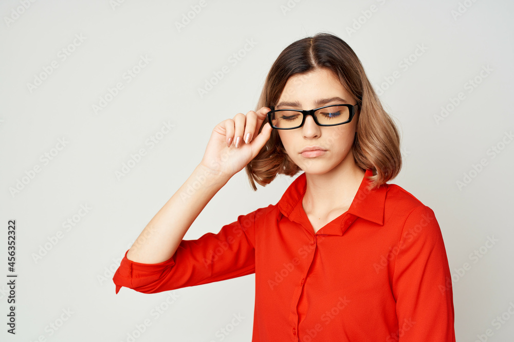cheerful business woman in a red shirt wearing glasses manager work