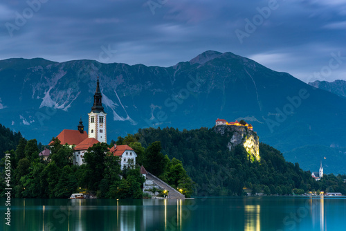 Illuminated Bled Castle and Bled Church on Lake Bled in Slovenia at Dusk