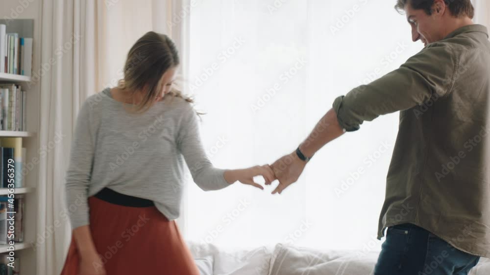 happy young couple dancing together at home celebrating having fun weekend smiling enjoying funny dance in living room successful relationship celebration 4k footage happy young couple dancing together at home celebrating having fun weekend smiling enjoying funny dance in living room successful relationship celebration 4k footage