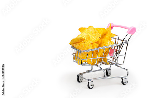 Cart full of corn chips tortilla on white background with place for text. photo