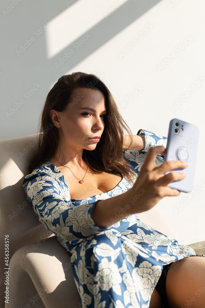 Pretty young woman with big breast posing in studio, wearing long