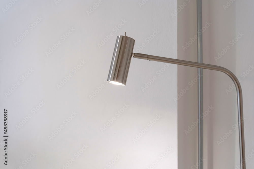 Modern standing lamp light bulb from stainless steel structure frame with white wall home decoration architecture building contemporary. Modern standing lamp light bulb from stainless steel structure frame with white wall home decoration architecture building contemporary.