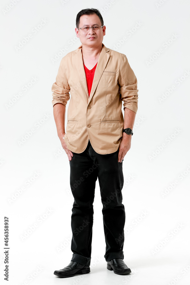 Portrait of Asian happy relax middle aged male model wearing eyeglasses standing look at camera put hands in pant pockets in front white background Portrait of Asian happy relax middle aged male model wearing eyeglasses standing look at camera put hands in pant pockets in front white background