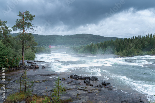 Storforsen, wild, huge waterfall on Pite River in Swedish arctic on a cloudy, rainy day of arctic summer. Norrbottens area, northwest of Alvsbyn. Wild nature of far north. Nature of Swedish Lapland