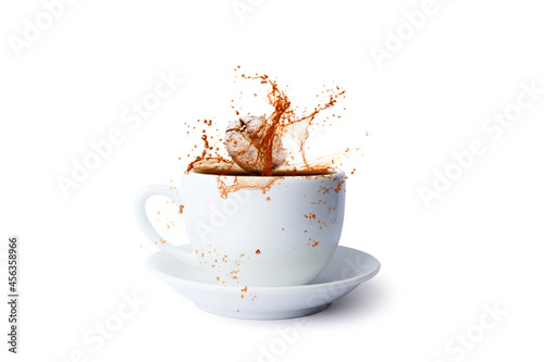 Pouring of hot coffee in cup and falling beans isolated on white background