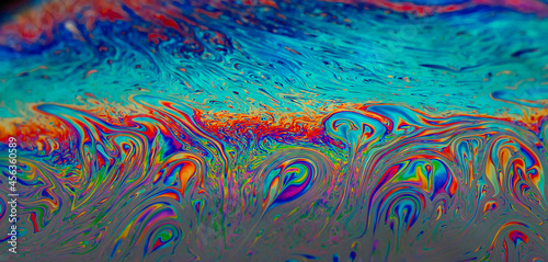 Abstract colourful background with patterns and rainbow effects in soap bubbles background.