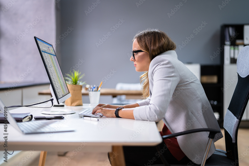 Woman Sitting In Bad Posture Working On Computer - obrazy, fototapety, plakaty 