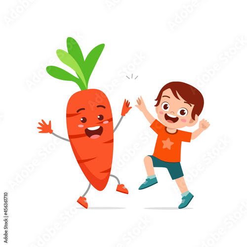 cute little boy stands with carrot character