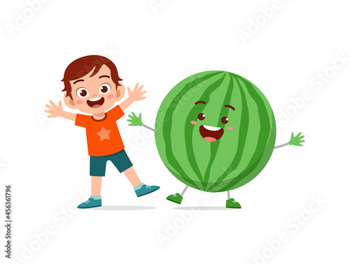 cute little boy stands with watermelon character