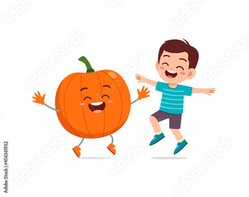 cute little boy stands with pumpkin character