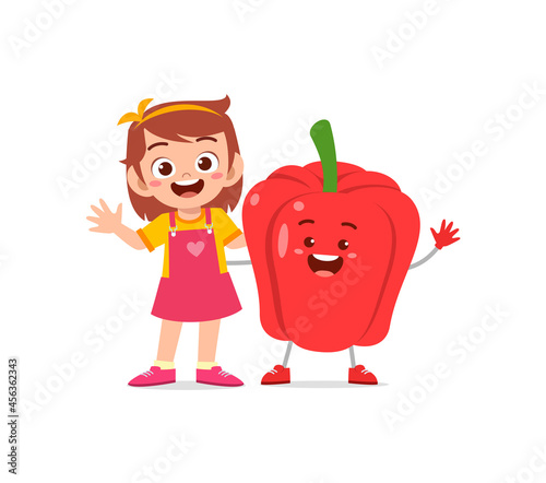 cute little girl stands with paprika character