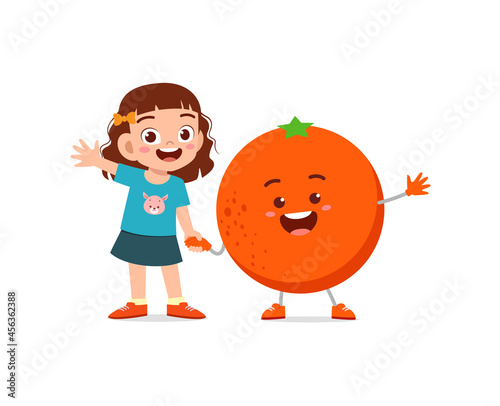 cute little girl stands with orange character