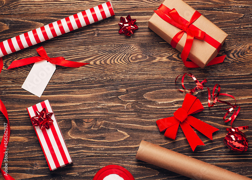 Gift wrapping for christmas and new year. Christmas background with gift boxes, ropes, paper handlebars and decorations on wooden background. Preparing for the holidays. Top view with copy space