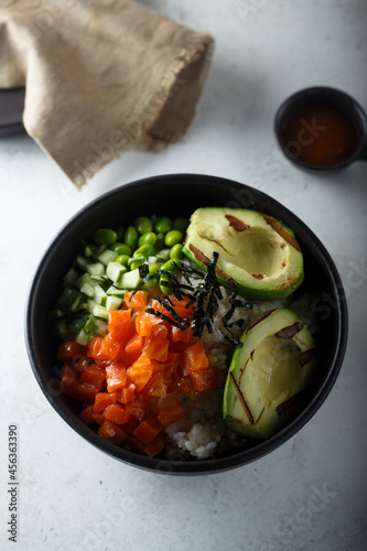 Healthy rice bowl with salmon and grilled avocado